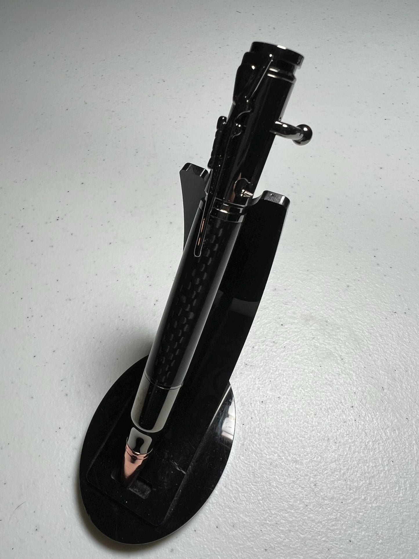 Bolt-action rifle pen gunmetal fittings with carbon fiber barrel.