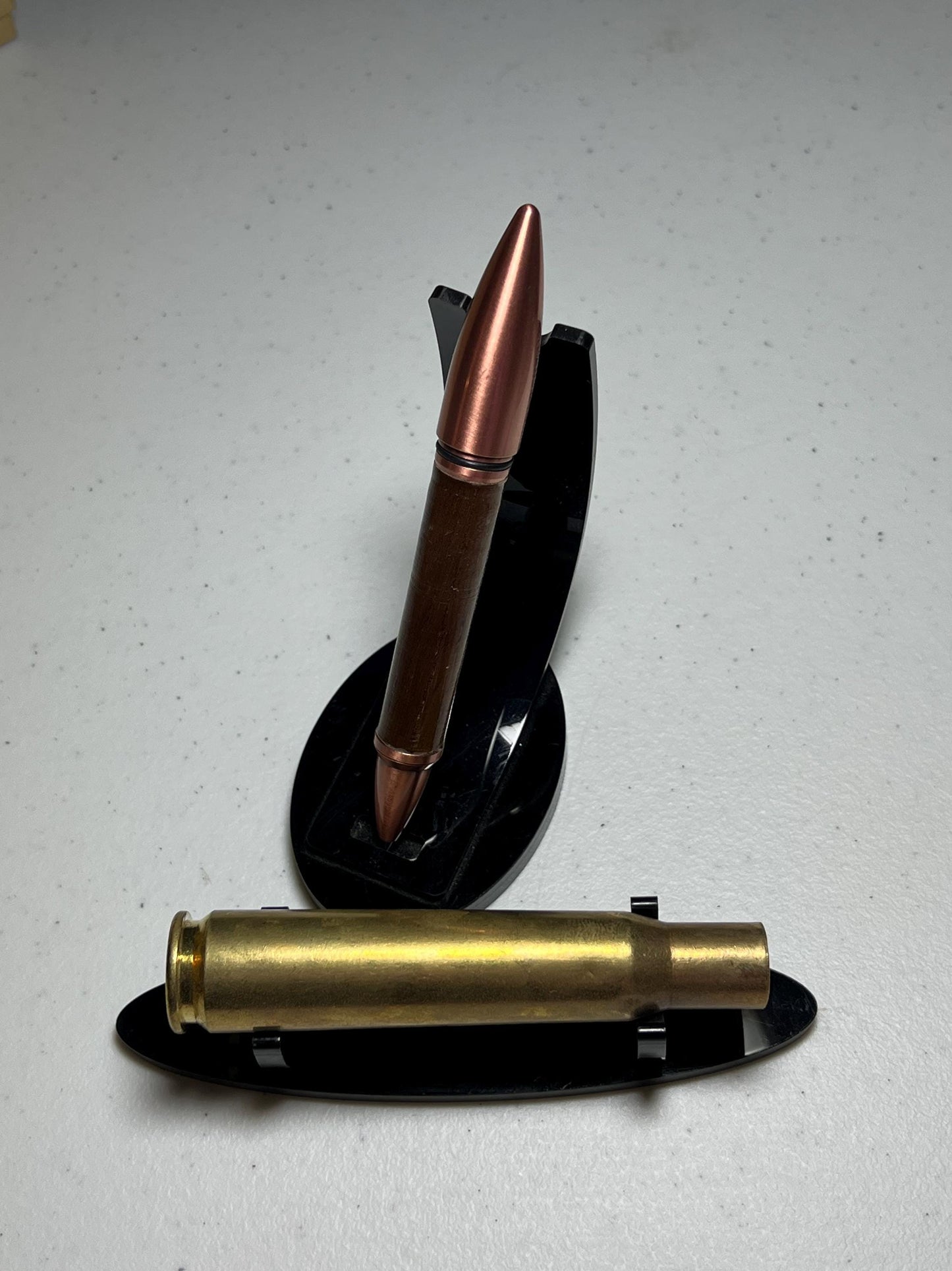 50 caliber bullet flip pen with wood from the USS Missouri Deck