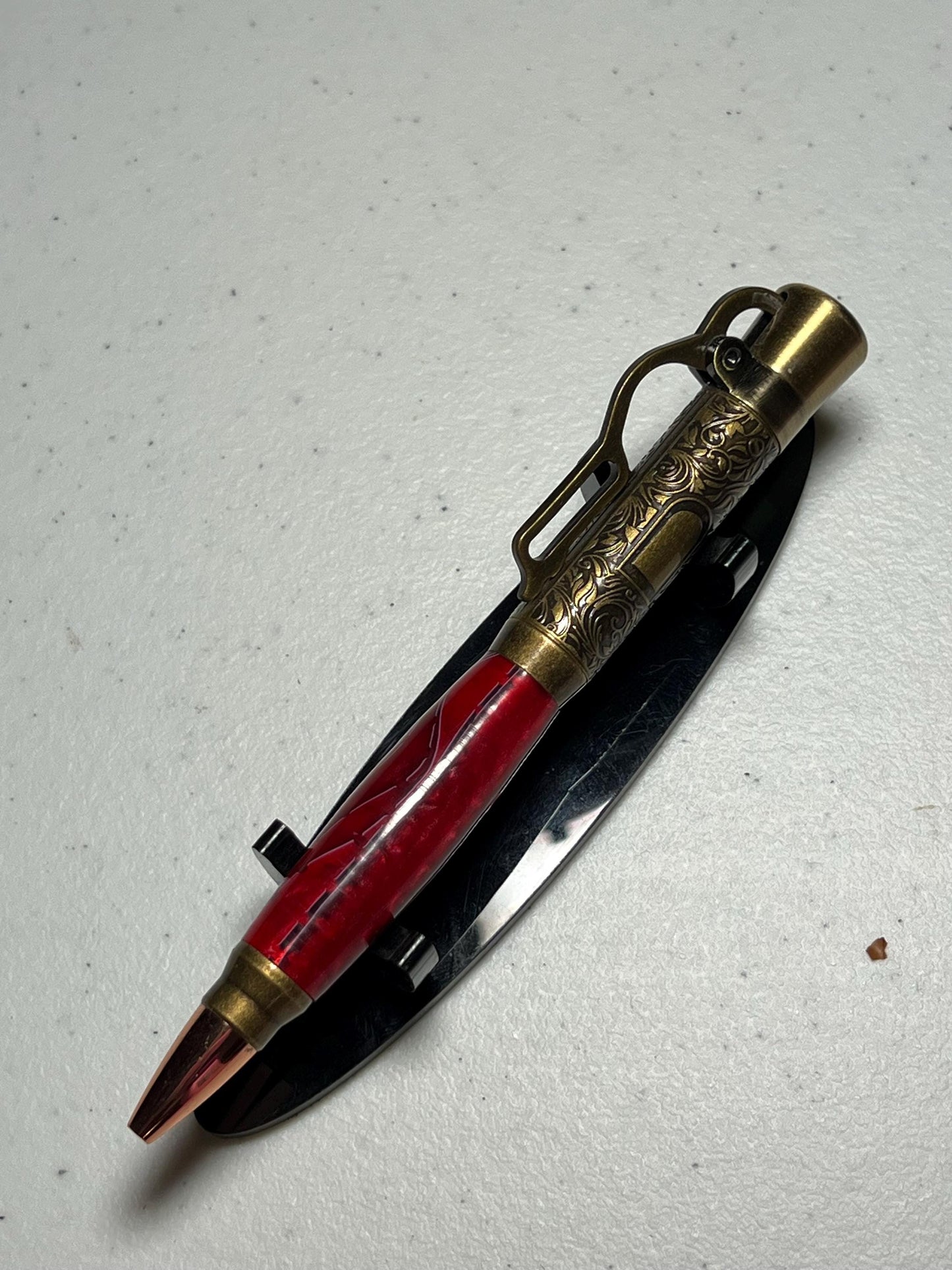 Lever action pen in antique brass with red grasshopper pattern barrel