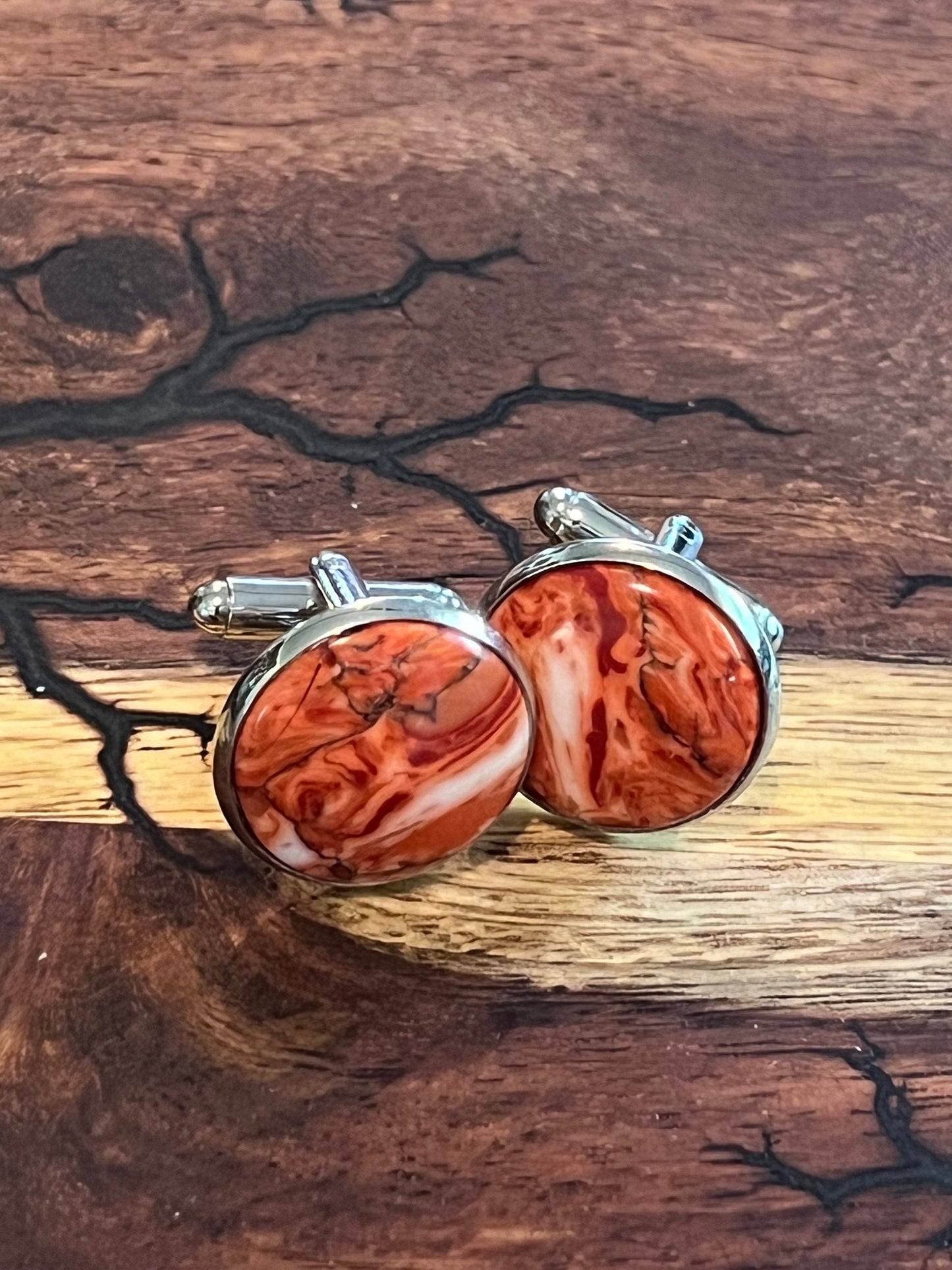 Rhodium cuff links and tie clip with red and white polymer settings