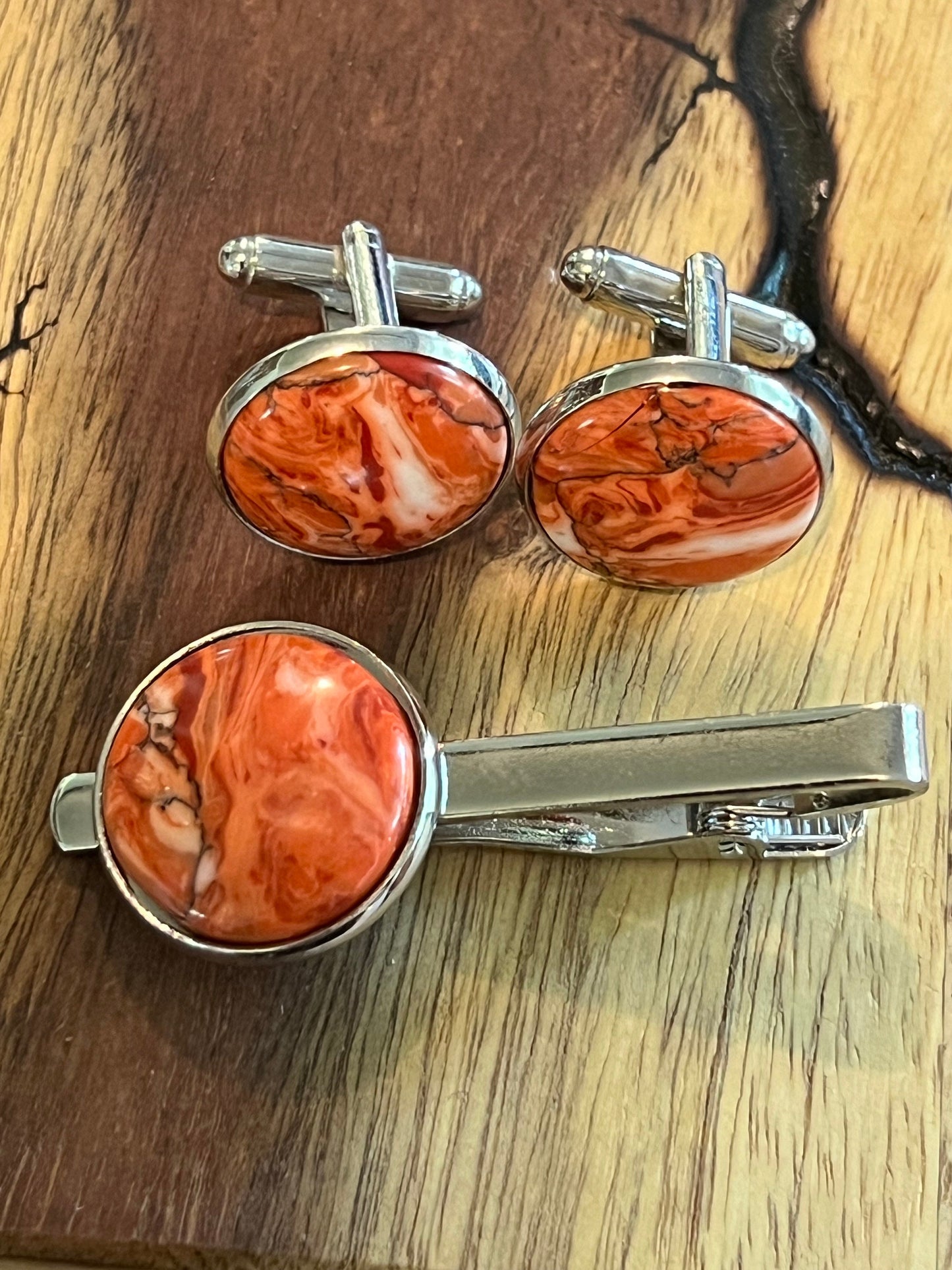 Rhodium cuff links and tie clip with red and white polymer settings