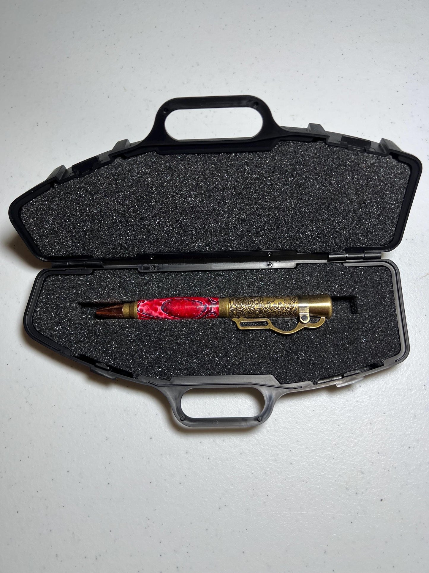 Lever action pen in antique brass with red grasshopper pattern barrel