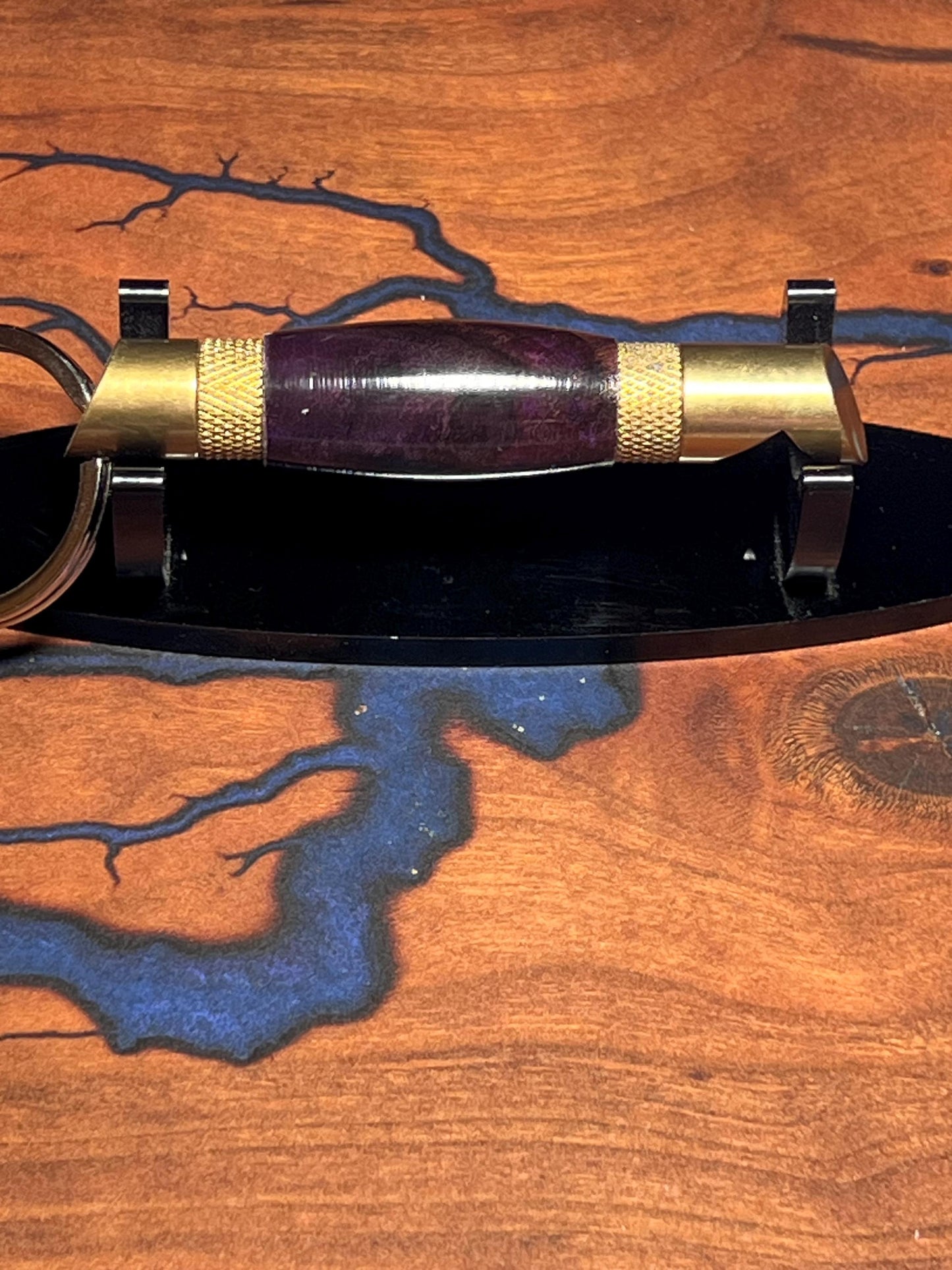 Brass bottle opener with purple burl body