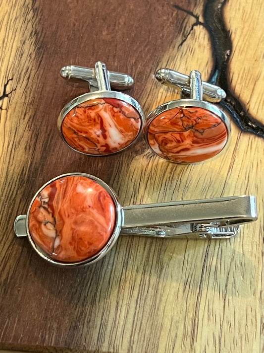 Rhodium cuff links and tie clip with red and white polymer settings