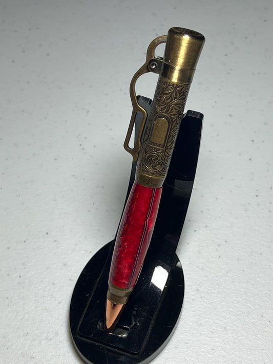 Lever action pen in antique brass with red grasshopper pattern barrel